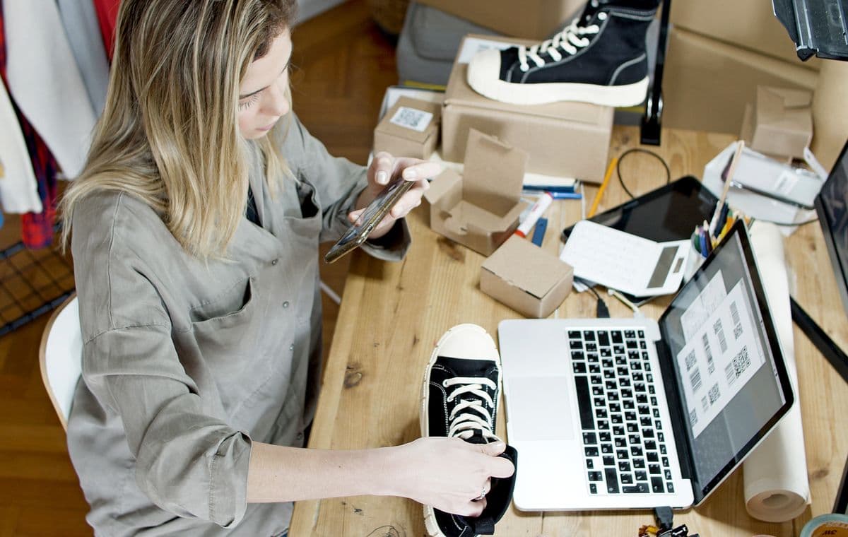 Small business owner working on a laptop in a shop